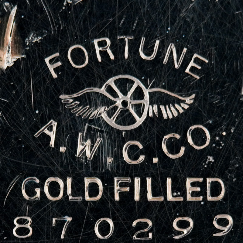 Watch Case Marking Variant for American Watch Case Co. of Toronto, Ltd. Fortune: Fortune
A.W.C.Co.
Gold Filled
[Wheel with Two Wings]