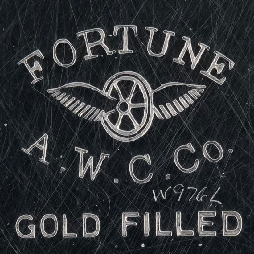 Watch Case Marking for American Watch Case Co. of Toronto, Ltd. Fortune: Fortune Winged Wheel A.W.C.Co. Gold Filled Case Made in Canada