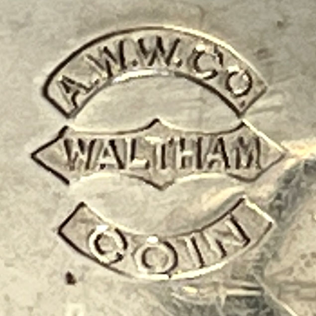 Watch Case Marking for American Watch Co. Coin Silver: A.W.W.Co. [in Embossed Arch] 
Waltham [in Embossed Pointed Cartouche] 
Coin [in Embossed Arch]