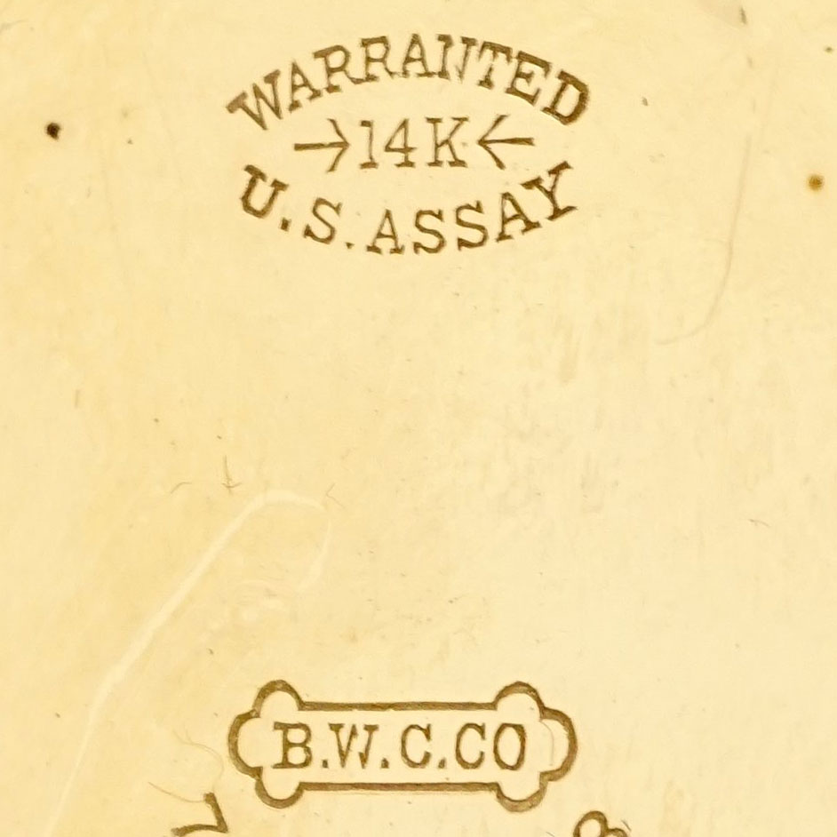 Watch Case Marking Variant for  14K: Warranted
14K
U.S. Assay
B.W.C.Co.
[Dogbone]
[Arrows]