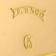 Watch Case Marking for Peters & Boss 18K: P.B&Co. in Ribbon K18 in Oval Embossed